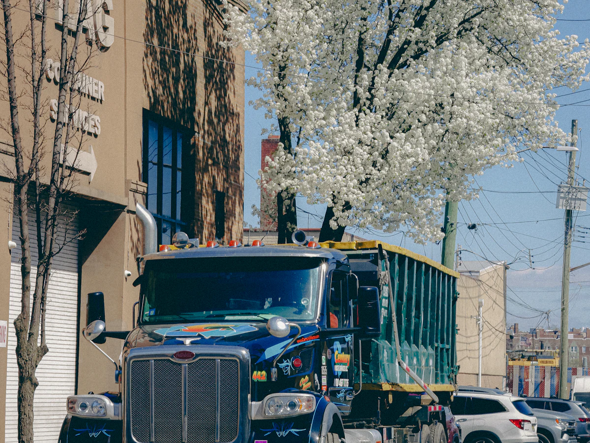 A roll-off truck working in a city neighborhood